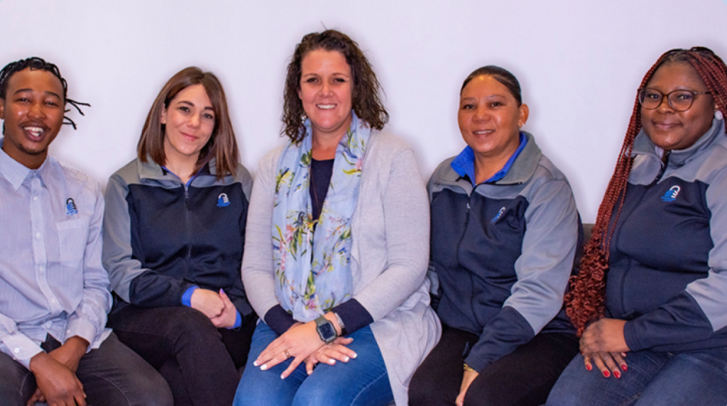 Team picture of some of Storage Locker's staffsitting together and smiling at the camera.